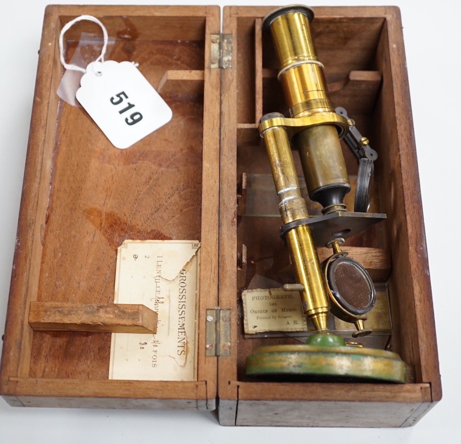 A cased brass monocular microscope